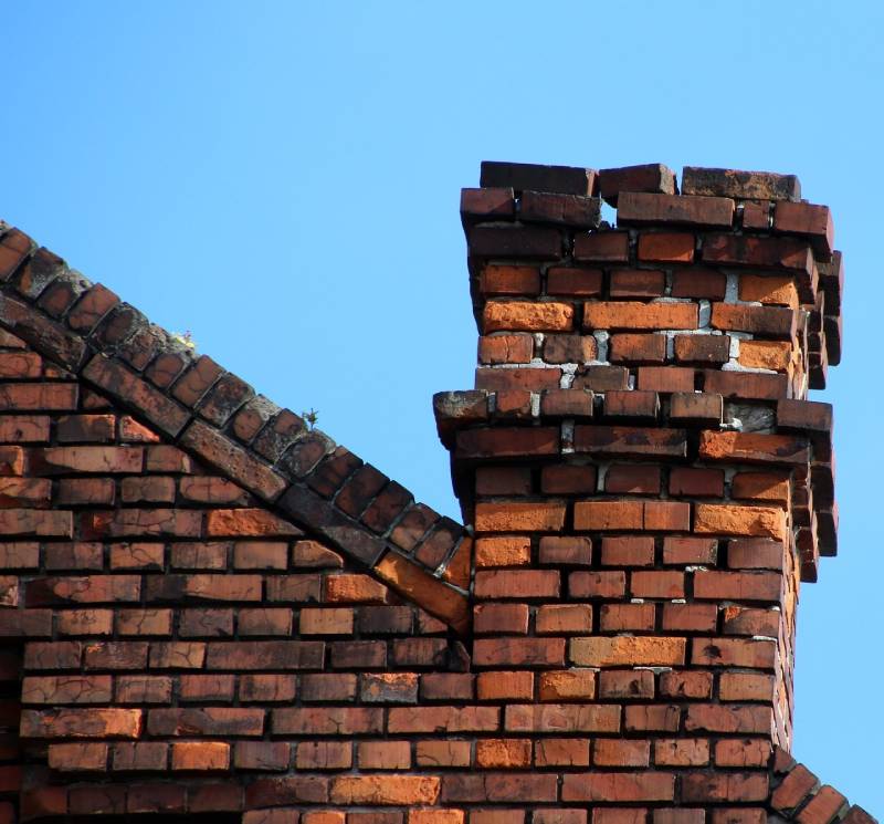 Damaged chimney on an Millbury home showing cracks and missing mortar